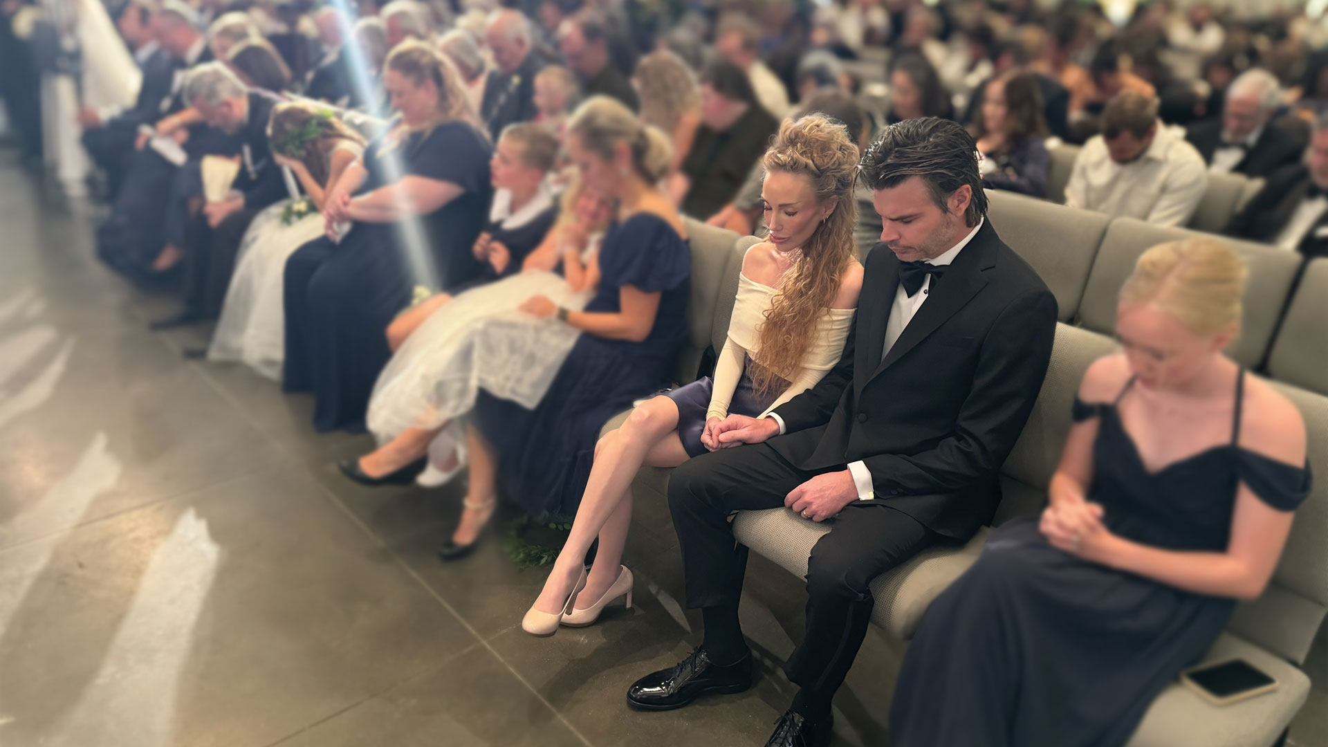 Ryan and Elizabeth Kaufmann praying at an assembly at Remnant Fellowship