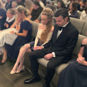 Ryan and Elizabeth Kaufmann praying during an assembly at Remnant Fellowship Church